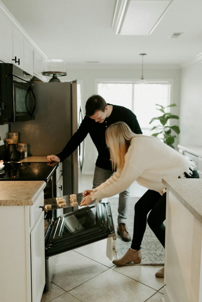 Couple using a stainless steel range in their kitchen